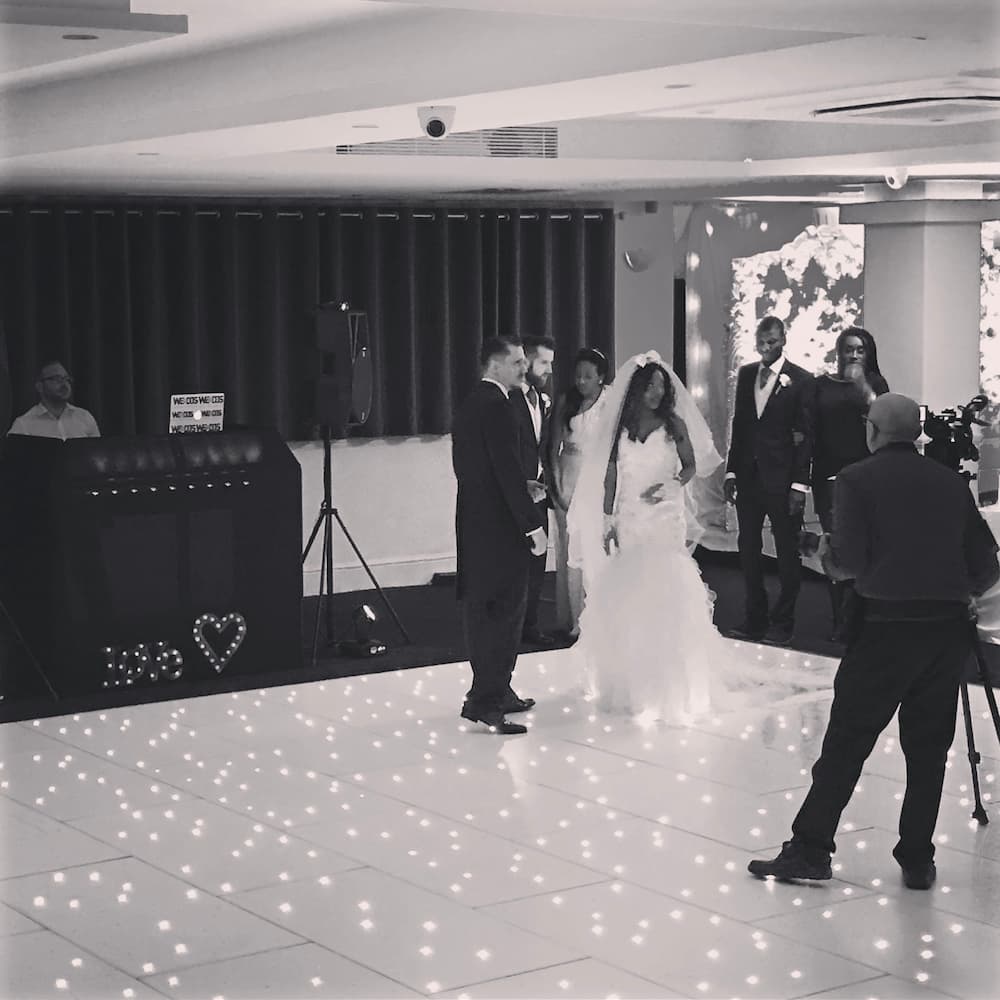 couple on a dancefloor taking wedding photos