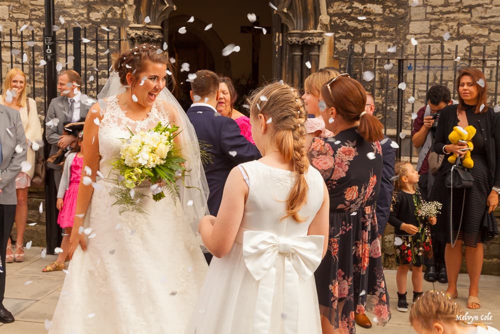 bride smiling outside her wedding venue